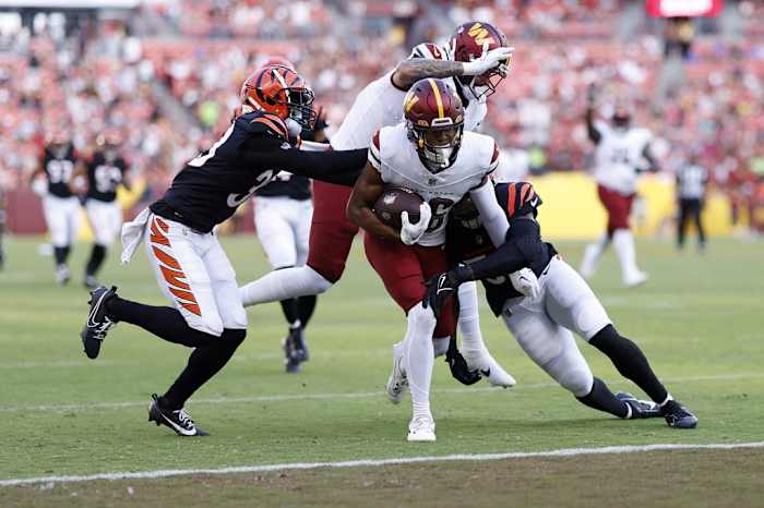 Washington Commanders wide receiver Mitchell Tinsley (86) scores a touchdown as Cincinnati Bengals linebacker Markus Bailey (51) defends during the second quarter at FedExField.